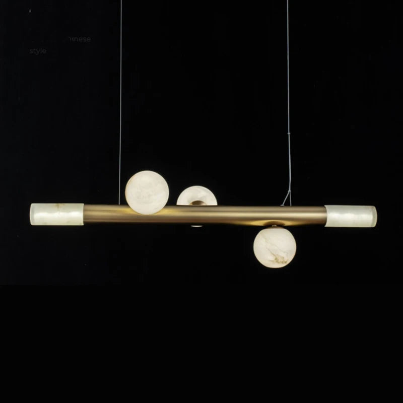 barre avec boule suspension table ronde en marbre éclairage salon de thé