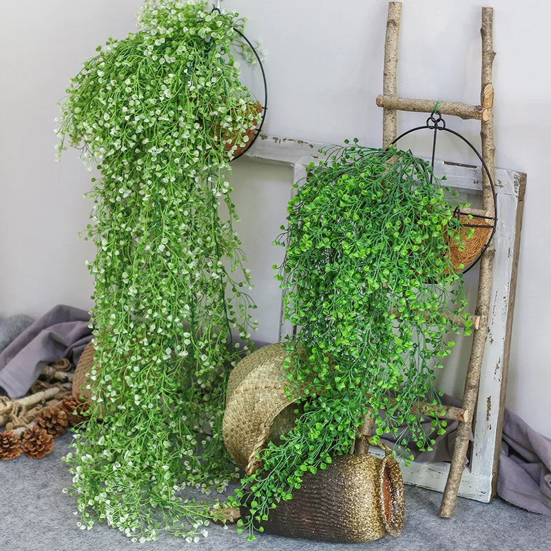 décoration murale en rotin avec feuilles et cloche dorée