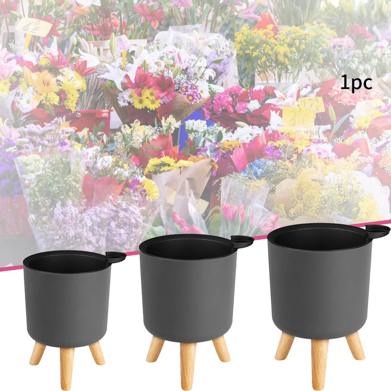 pot de fleurs rond sur pied en bois pour plantes